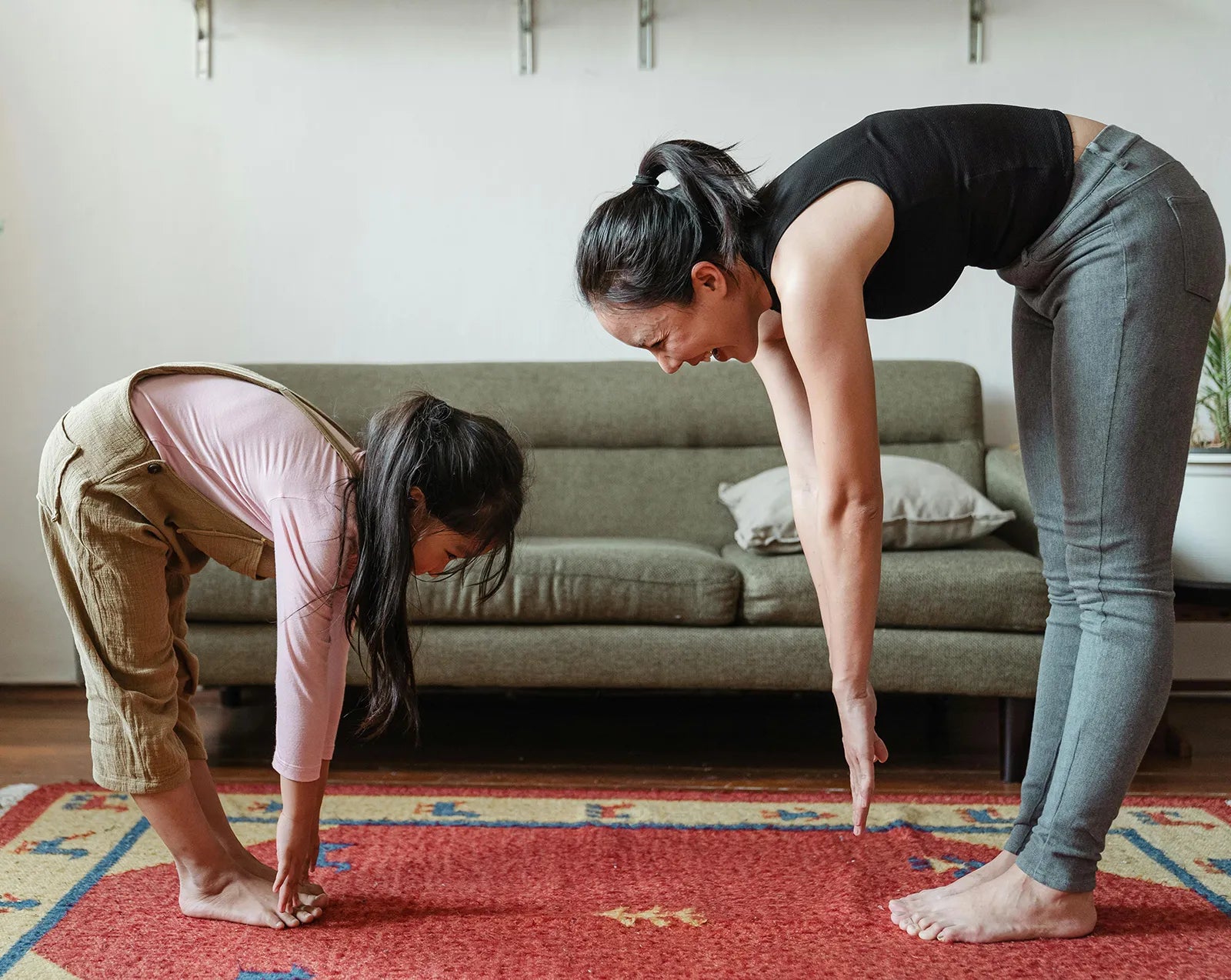 busy mom completing a fitness online course with daughter
