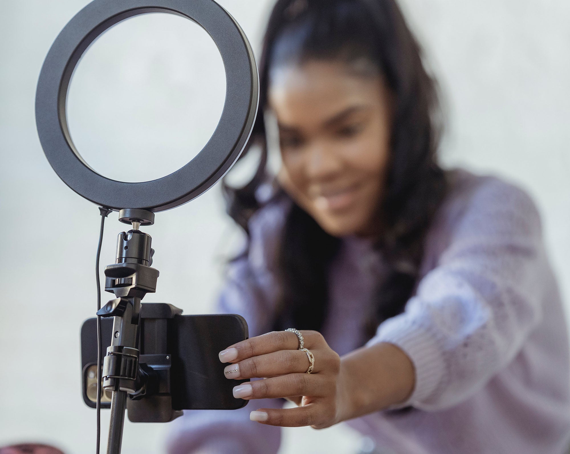 Course creator setting up camera to record a lesson for her course built on Kajabi using Kajabi templates by Just Add Your Brand™ Kajabi Template Shop