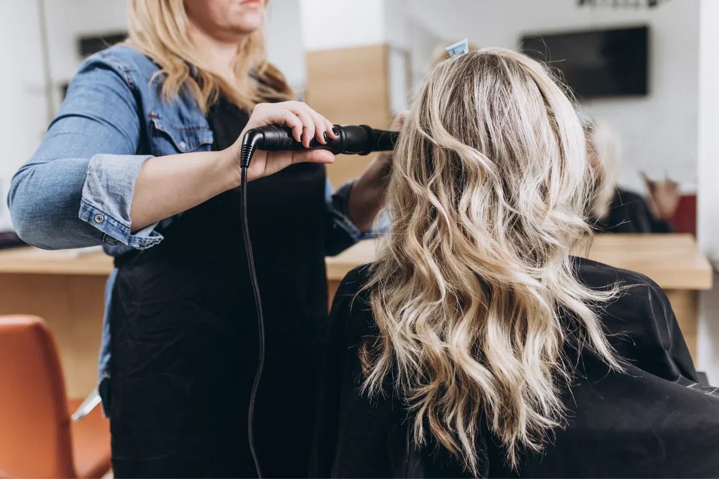 salon stylist curling hair